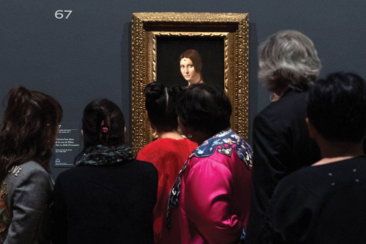 Visitors admire La Belle Ferronnière at the Louvre show Photo: Aurore Marechal/ABACA/PA Images