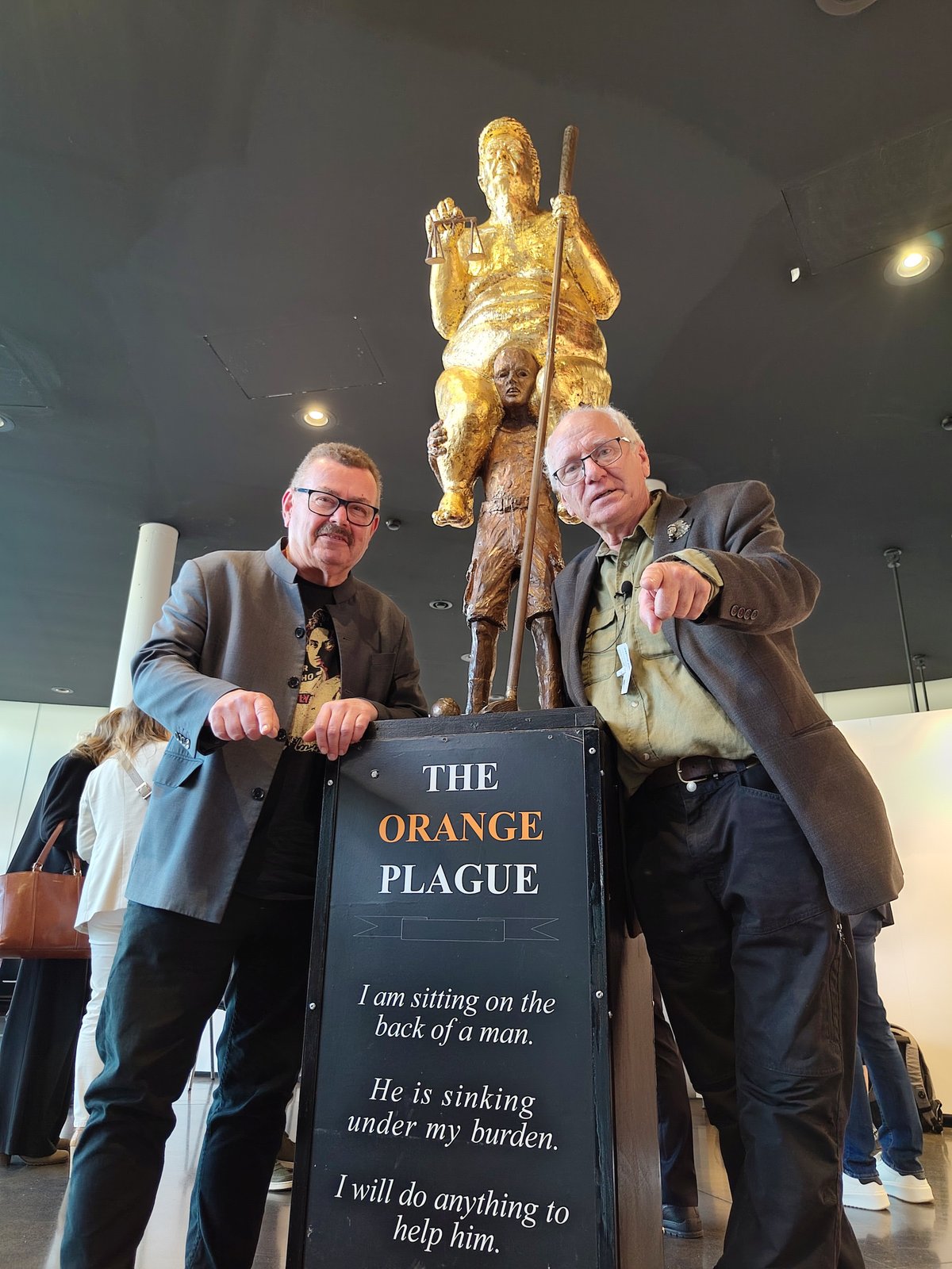 Per Clausen (left), a Danish member of the European Parliament, and the artist Jens Galschiøt (right) pose with the latter's sculpture The Orange Plague at the European Parliament building in Strasbourg, France Photo courtesy Jens Galschiøt