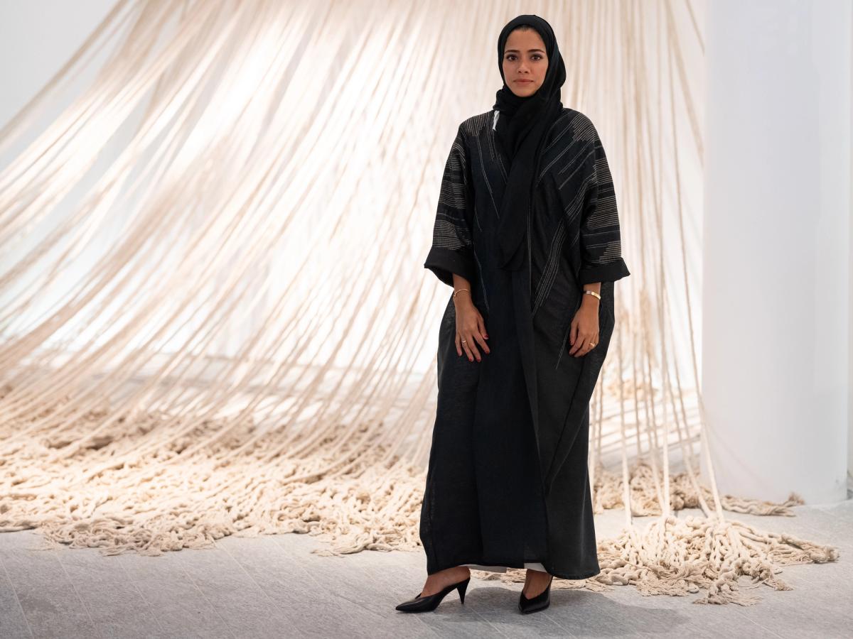 Afra Al Dhaheri in front of her work Weighing the Line at Louvre Abu Dhabi
Photo: Augustine Paredes – Seeing Things. Courtesy Department of Culture and Tourism, Abu Dhabi. Artwork © the artist