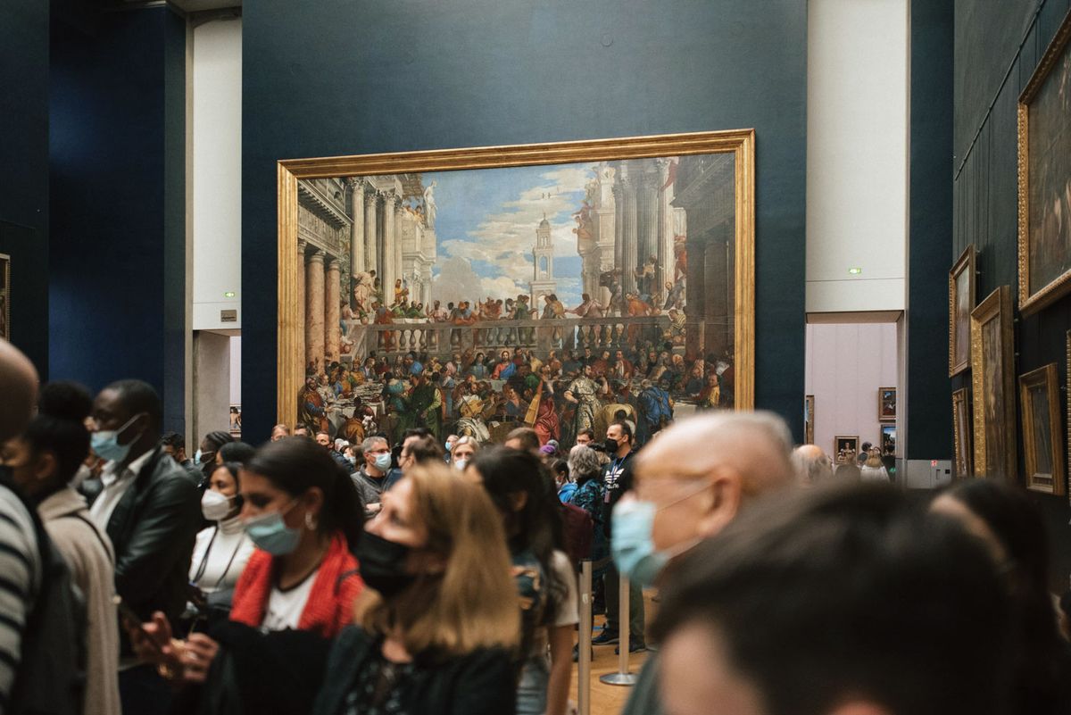 Masked visitors look at the Mona Lisa in the Musée du Louvre. In 2021 it welcomed around 2.8 million visitors—less than a third of the people it did in 2018, its record year Photo: Francesco Zivoli/Unsplash