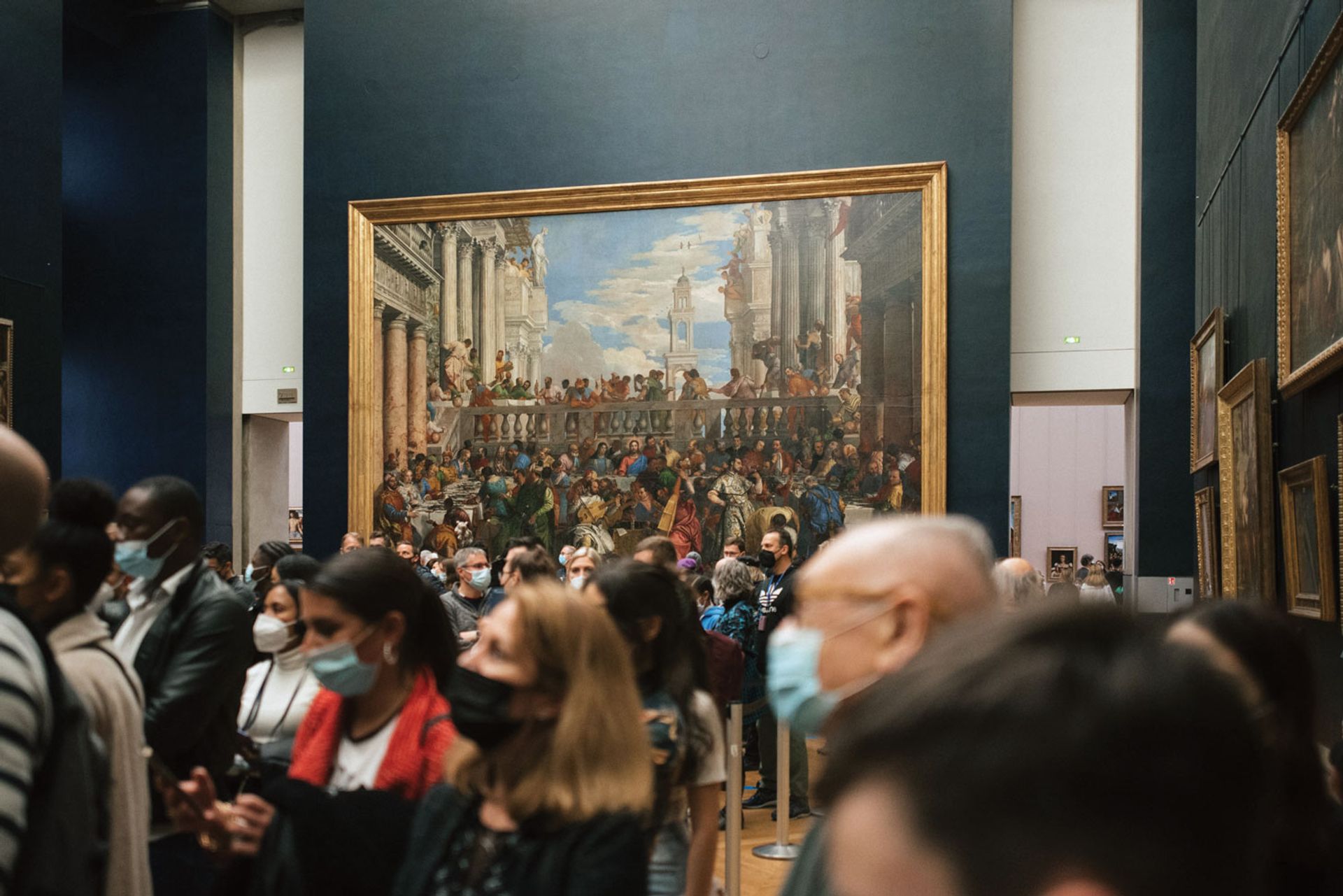 Masked visitors look at the Mona Lisa in the Musée du Louvre. In 2021 it welcomed around 2.8 million visitors—less than a third of the people it did in 2018, its record year Photo: Francesco Zivoli/Unsplash