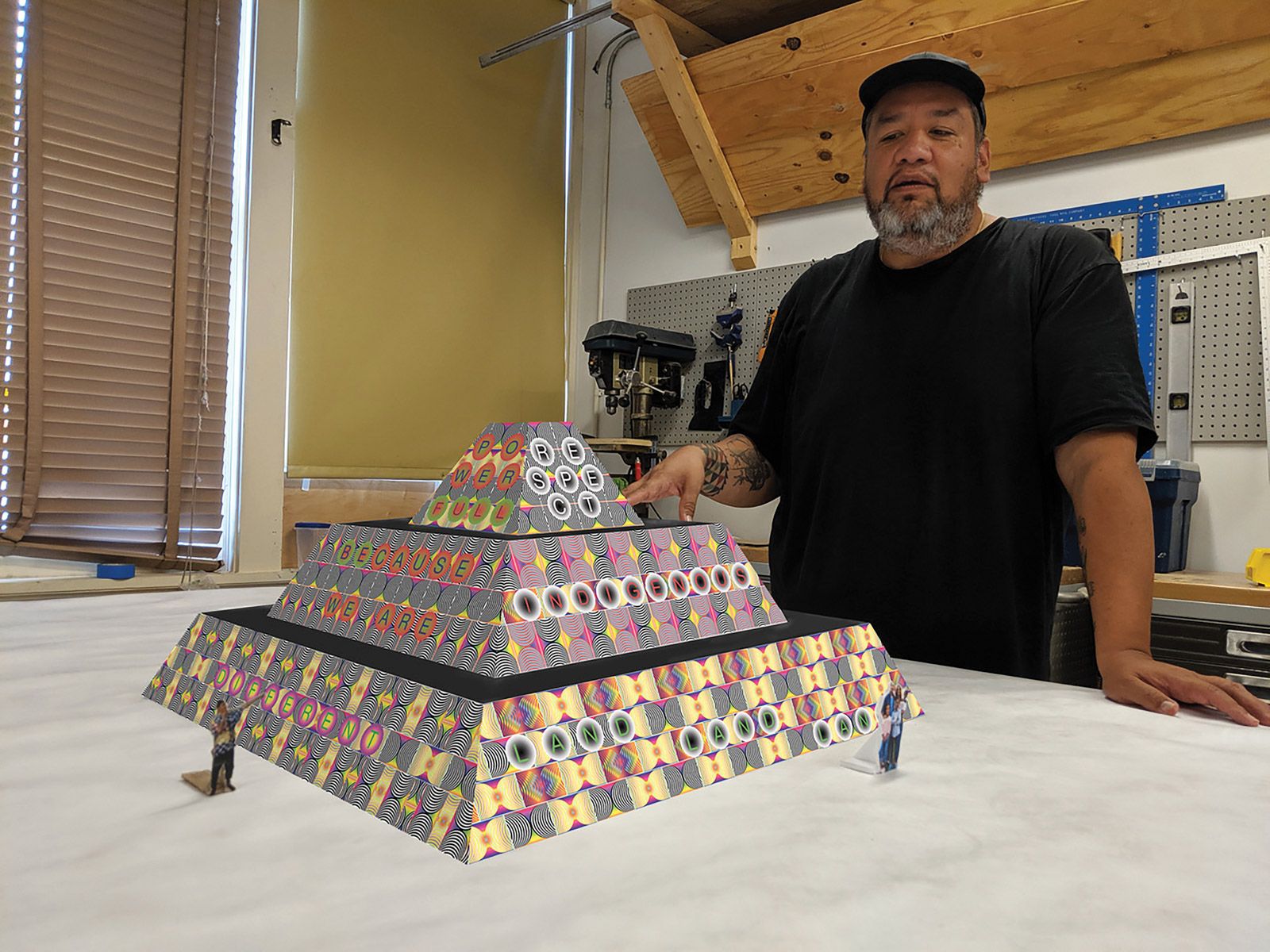 Choctaw-Cherokee artist Jeffrey Gibson with a model of Because Once You Enter My House It Becomes Our House (2020) Courtesy of the artist and Socrates Sculpture Park