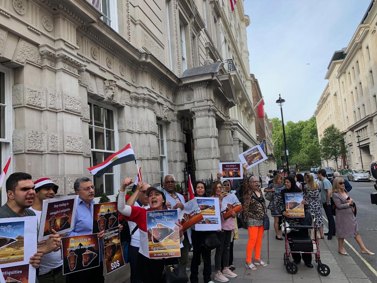 Protestors from an organisation calling itself Egyptian House gather outside Christie's this evening to protest the sale of an Egyptian head with features of King Tutankhamun Kabir Jhala