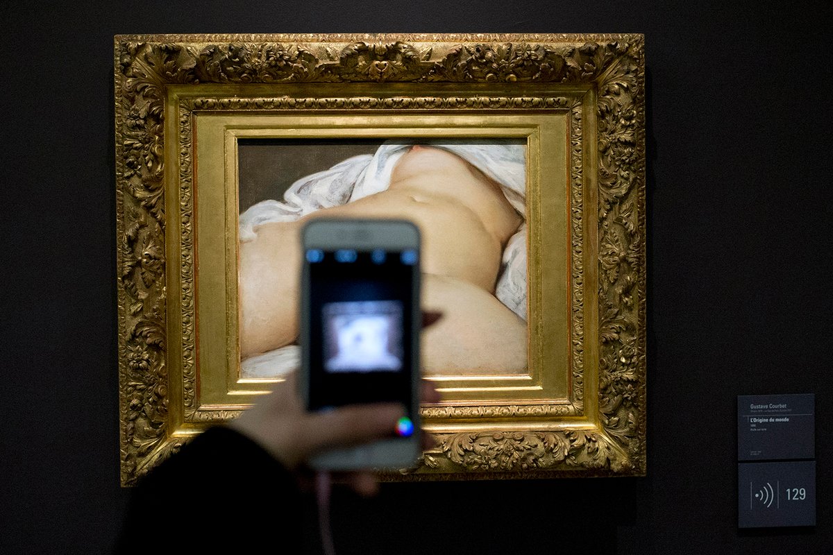 A visitor takes a picture of Gustave Courbet's Origin of the World (1866) at the Musée d'Orsay, in Paris AP Photo/Francois Mori