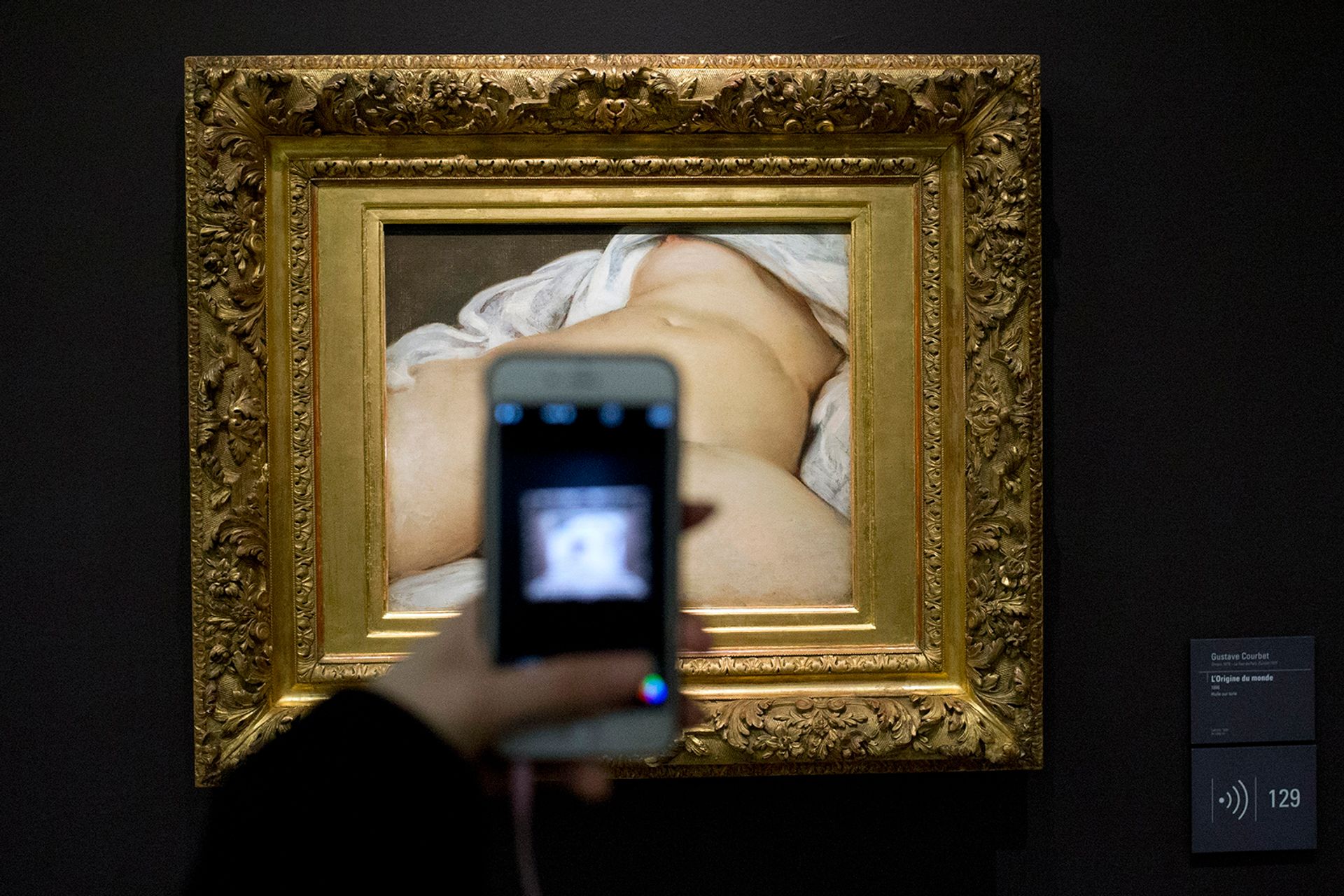 A visitor takes a picture of Gustave Courbet's Origin of the World (1866) at the Musée d'Orsay, in Paris AP Photo/Francois Mori