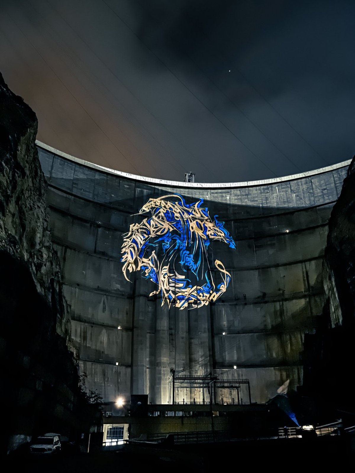 Street artist Pokras Lampas's designs projected on a hydroelectric plant in Dagestan Image: Twitter/Pokras Lampas