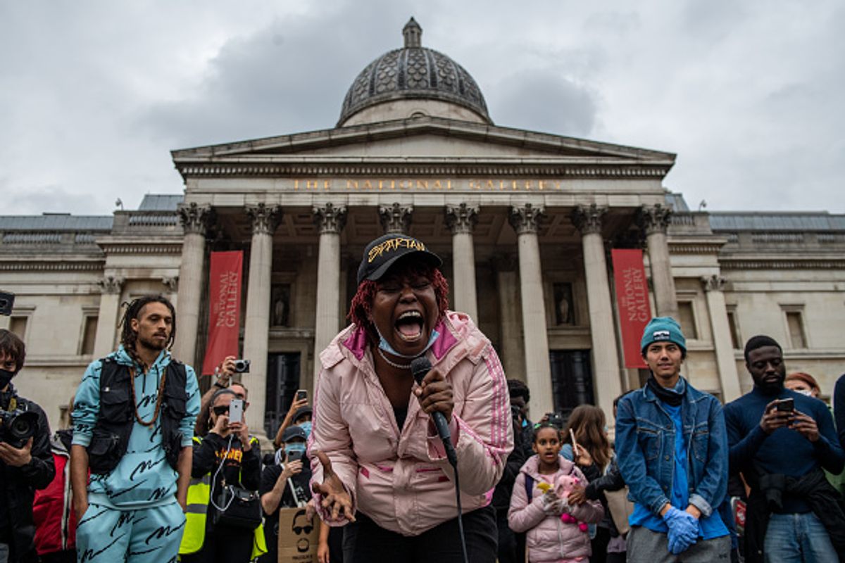 A Black Lives Matter supporter sings to crowds who marched with her in front of the National Gallery in Trafalgar Square on 12 June in London. Photo by Chris J Ratcliffe/Getty Images