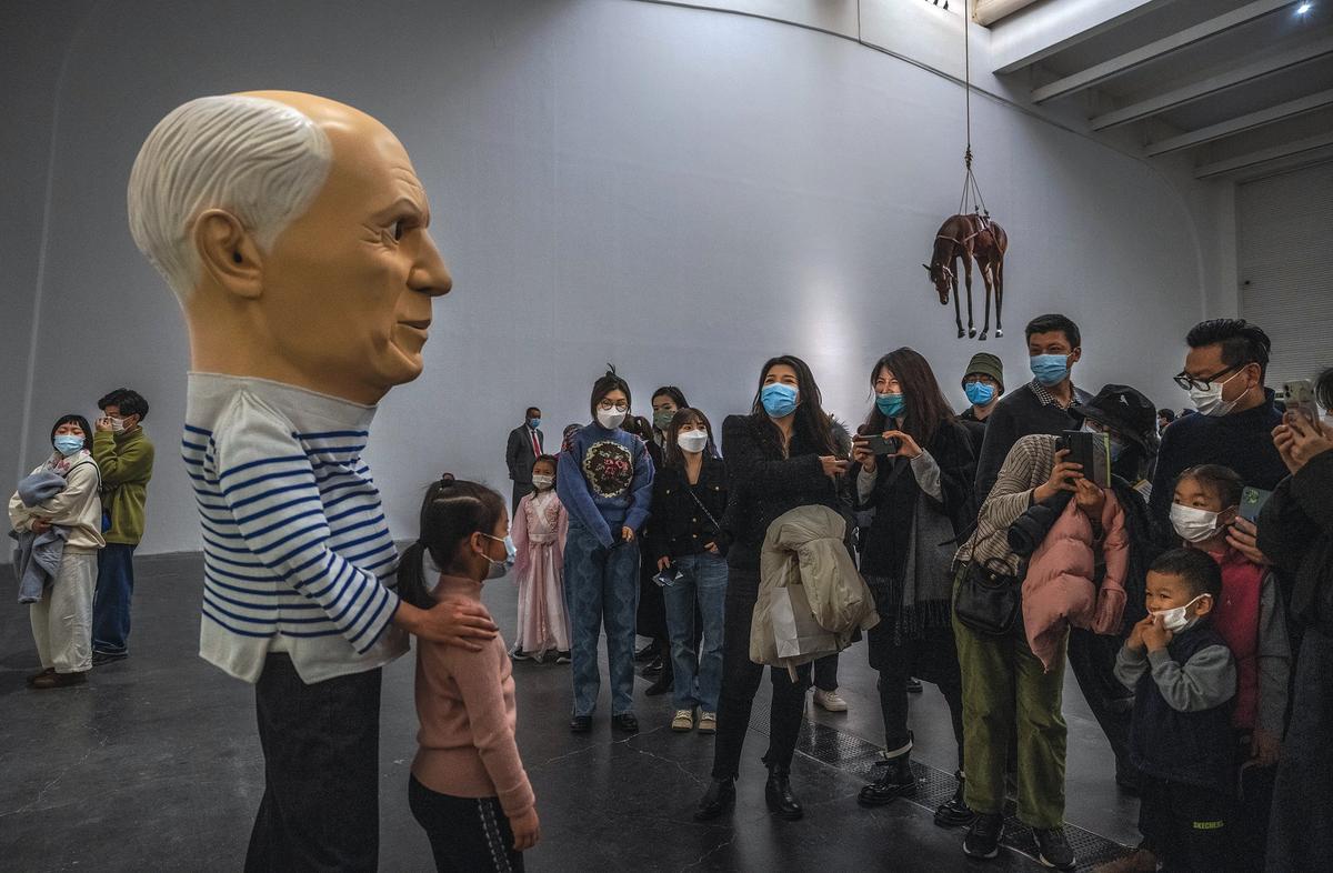 Surreal times: masked visitors at the UCCA Center for Contemporary Art’s Maurizio Cattelan exhibition in Beijing last November Photo: Kevin Frayer/Getty Images