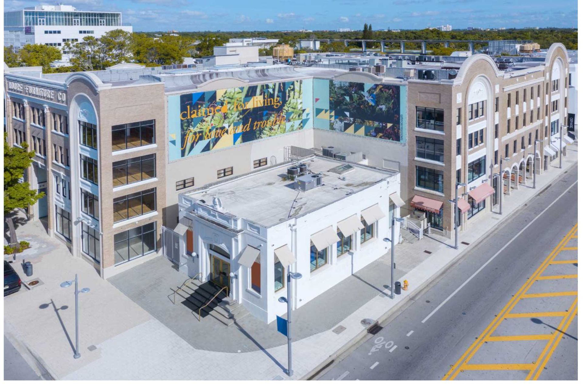 Aerial view of The Moore Building, in Miami Design District featuring billboard artwork by Adler Guerrier, in  partnership with For Freedoms 