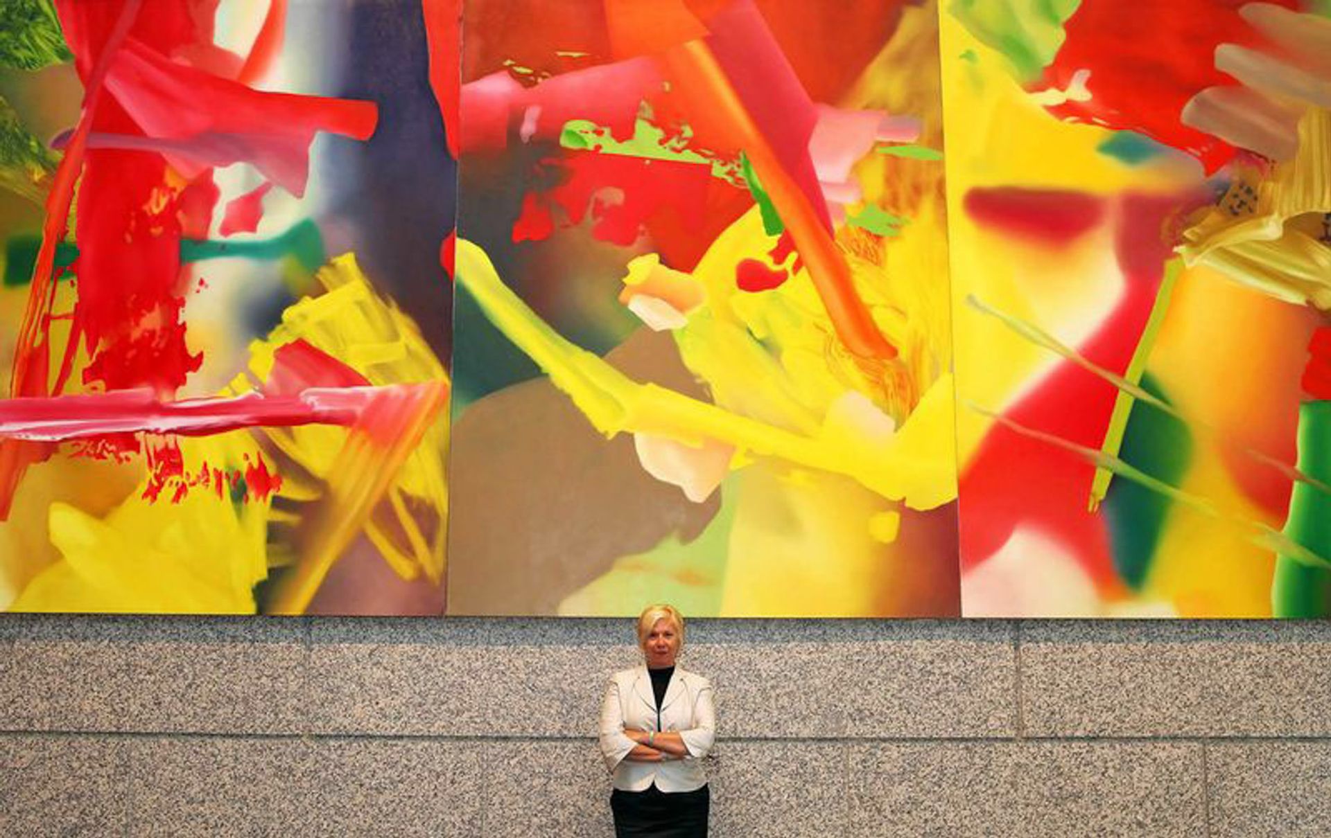 Liz Christensen, Deutsche Bank’s senior art director, in front of the recently  sold Faust (1981) by Gerhard Richter Photo by Nicole Bengiveno/The New York Times via Redux.