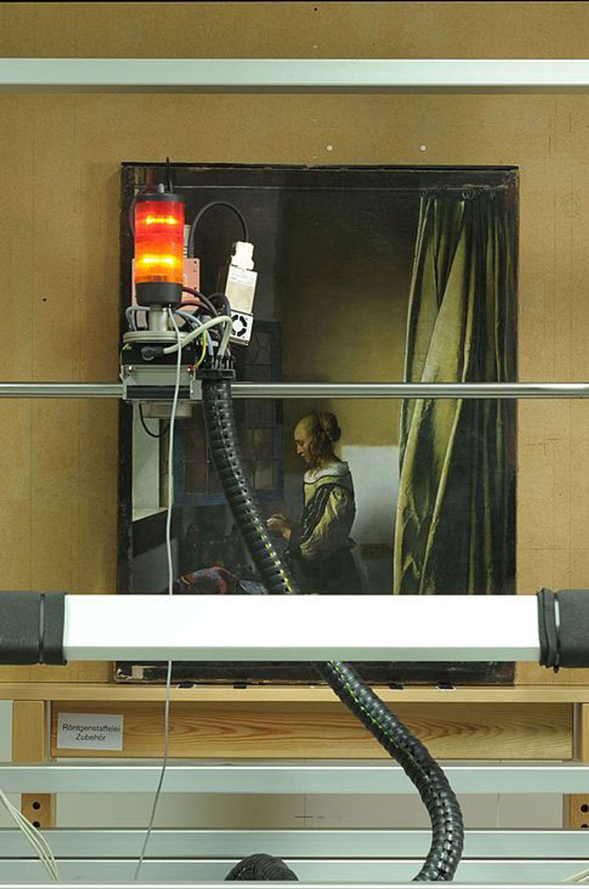 During the restoration of Vermeer's Girl Reading a Letter at an Open Window it was discovered that a depiction of Cupid had not been overpainted by the artist © Staatliche Kunstsammlungen Dresden