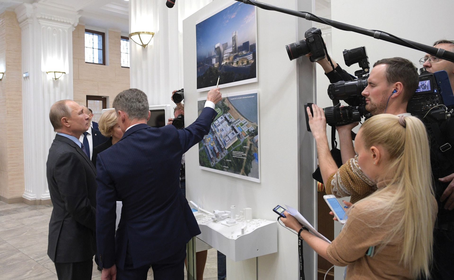 Russian president Vladimir Putin and local officials examine plans for one of the regional cultural centres in 2019 Kremlin.ru