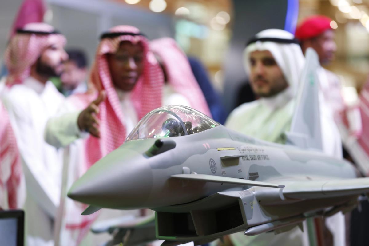 Visitors look at a display model of a Saudi Air Force Eurofighter Typhoon jet, manufactured by BAE Systems Plc, at the Armed Forces Exhibition for Diversity of Requirements and Capabilities (AFED) in Riyadh, Saudi Arabia, on 27 February. Mohammed Almuaalemi/Bloomberg via Getty Images