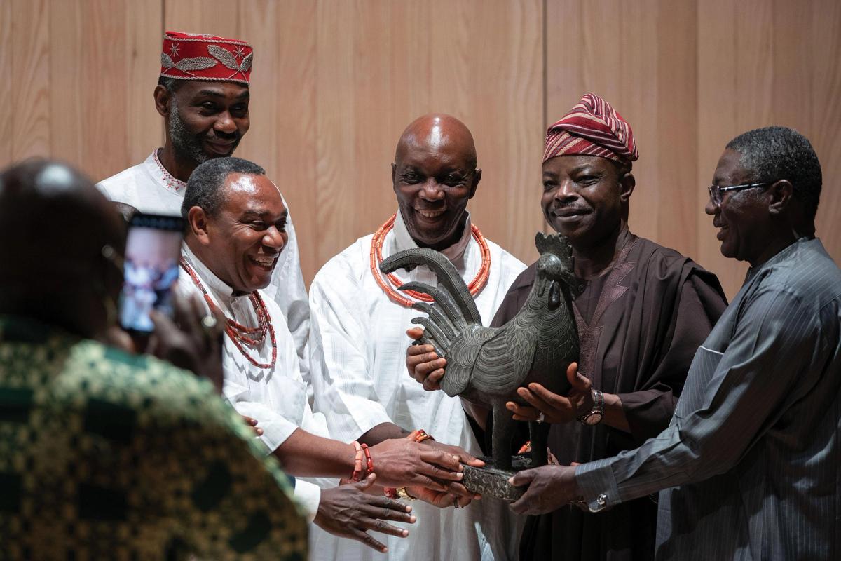 Nigerian delegates including Prince Aghatise Erediauwa (centre) and Abba Isa Tijani (far right), the director of the National Commission for Museums and Monuments, received a Benin sculpture of a cockerel in a handover ceremony last year at Jesus College, Cambridge © Joe Giddens/PA Images/Alamy