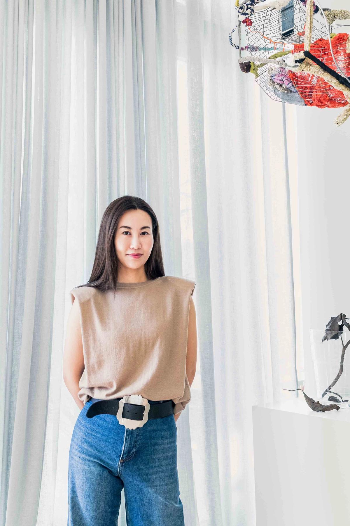 Yan Du pictured with a work by Sonia Gomes (hanging) and sculpture by Martin Creed Photo: Kenny X. Li