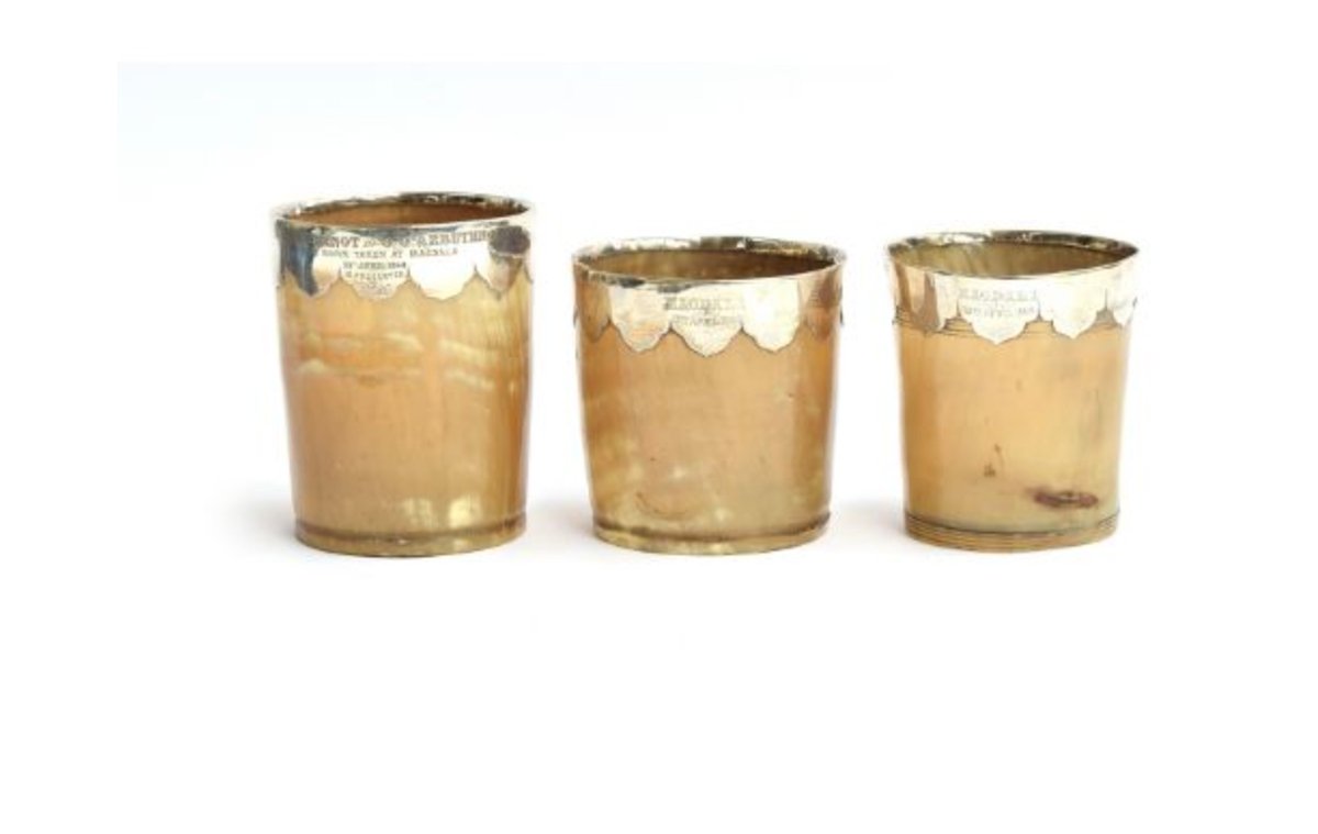 The three horn beakers, with silver mounts added later in England, are inscribed “Magdala” and “taken at Magdala”