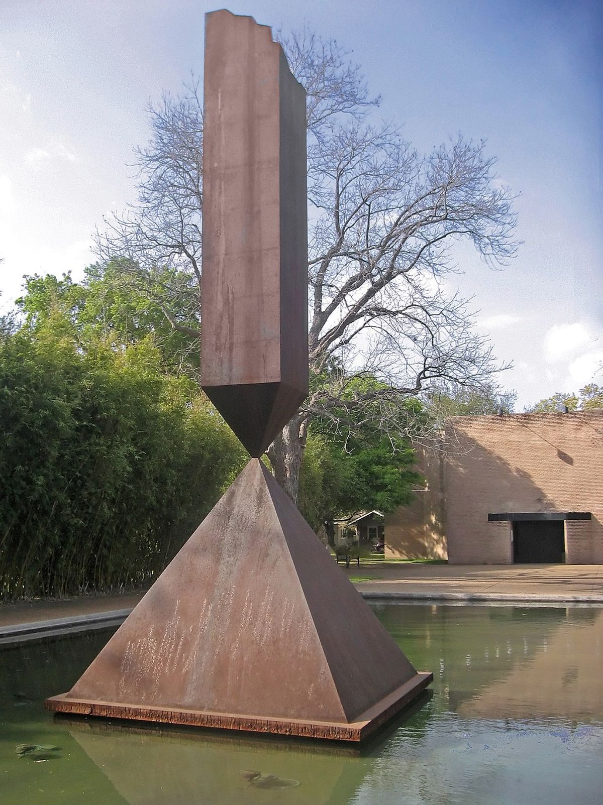 Broken Obelisk by Barnett Newman in front of the Rothko Chapel Photo by Jim Evans via Wikimedia Commons