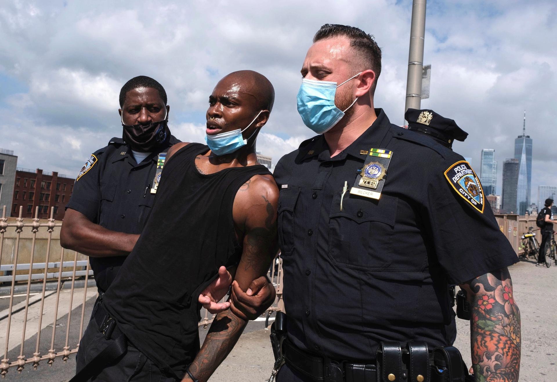 Officers arrest a photographer on Brooklyn Bridge during a clash between officers and Black Lives Matter protesters in July. Yuki Iwamura/AP/Shutterstock