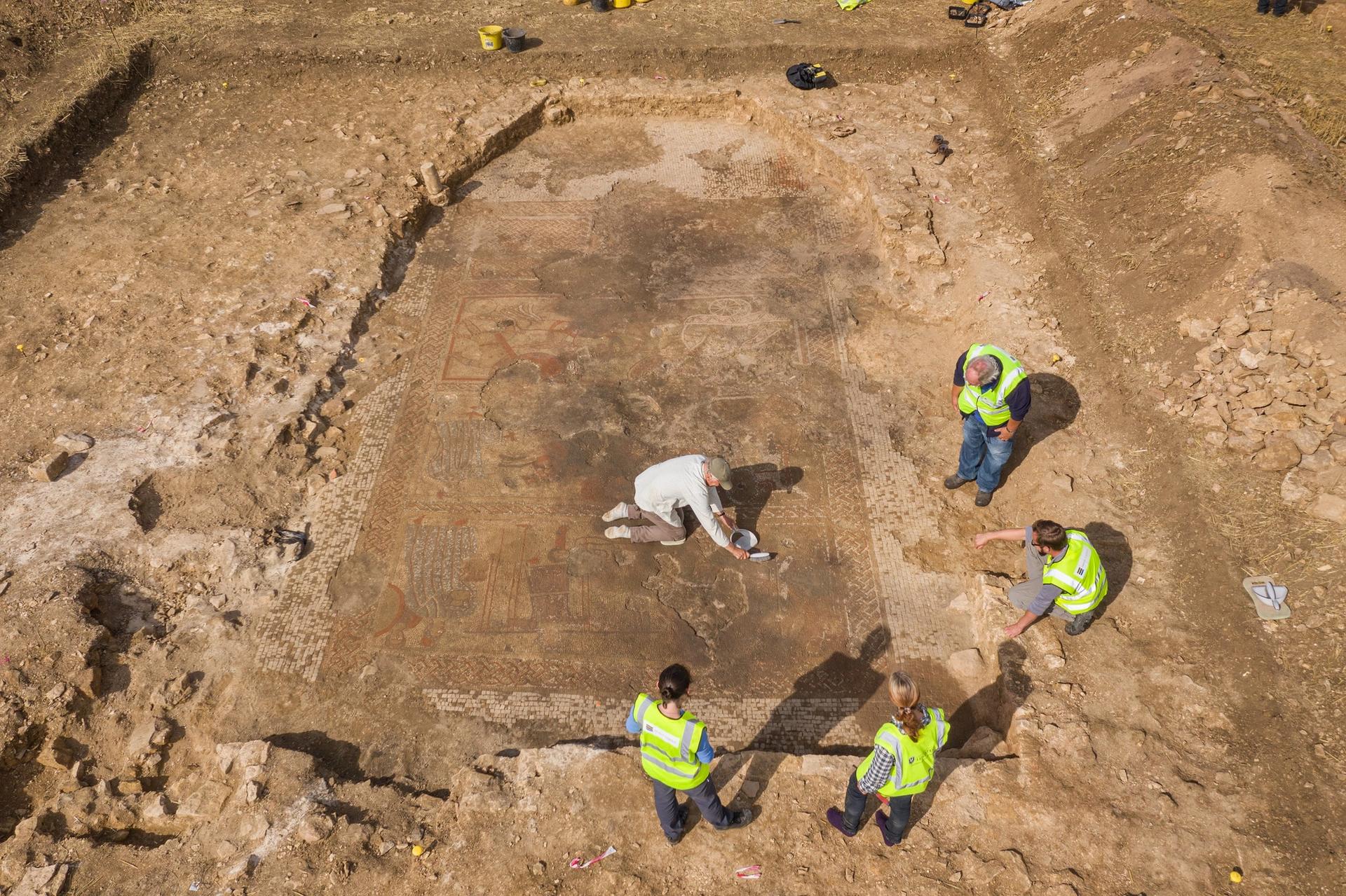 This drone photograph captures the scale of the newly discovered Rutland mosaic and surrounding villa, with Historic England staff and team members from ULAS/University of Leicester during the excavations © Historic England Archive