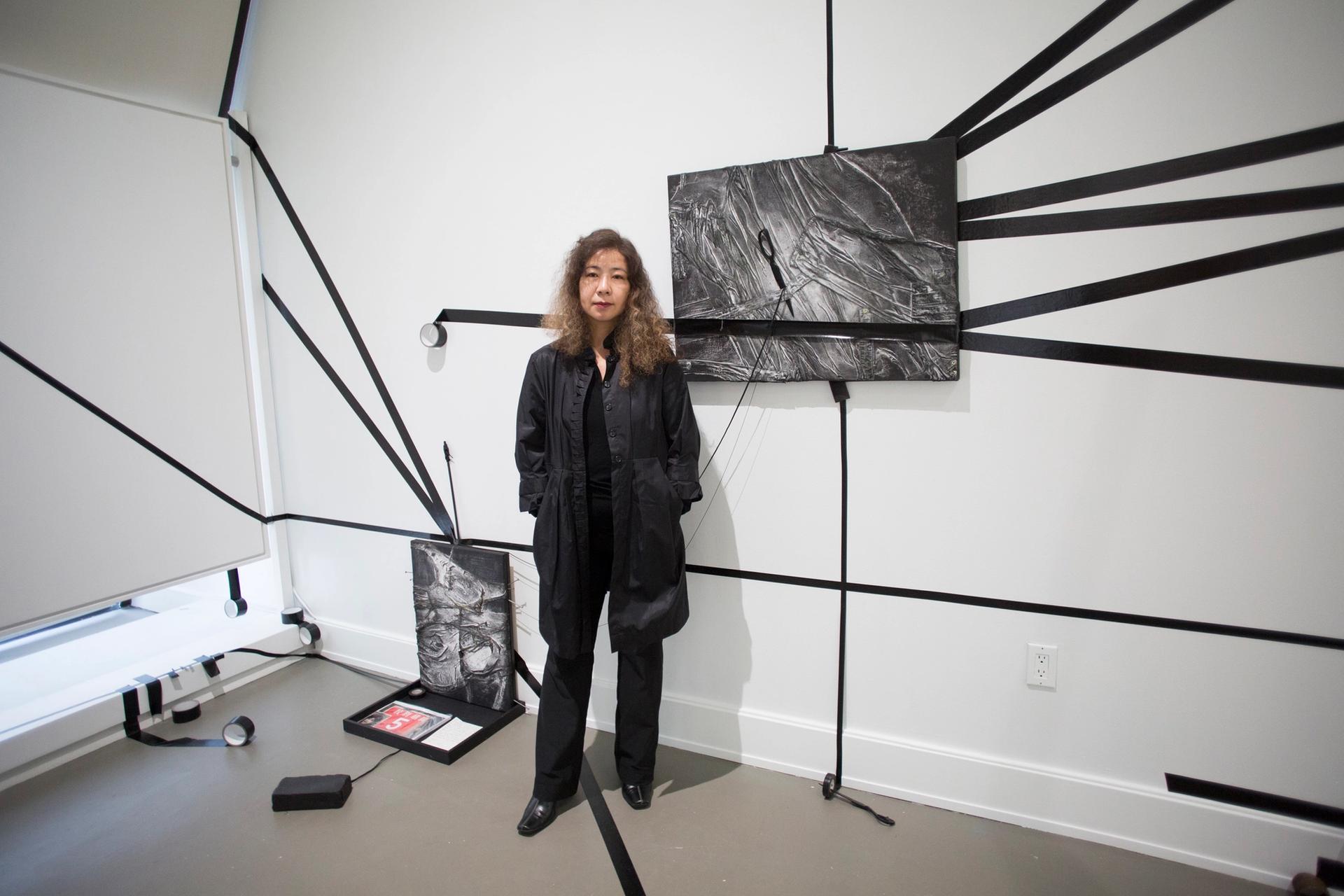 Stella Zhang with her installation Sealed Memory, at the  Chinese Culture Center in San Francisco Photo: Pamela Gentile