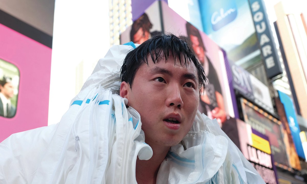 artist puts on 27 hazmat suits for Times Square performance protesting China’s Covid restrictions artist puts on 27 hazmat suits for Times Square performance protesting China’s Covid restrictions