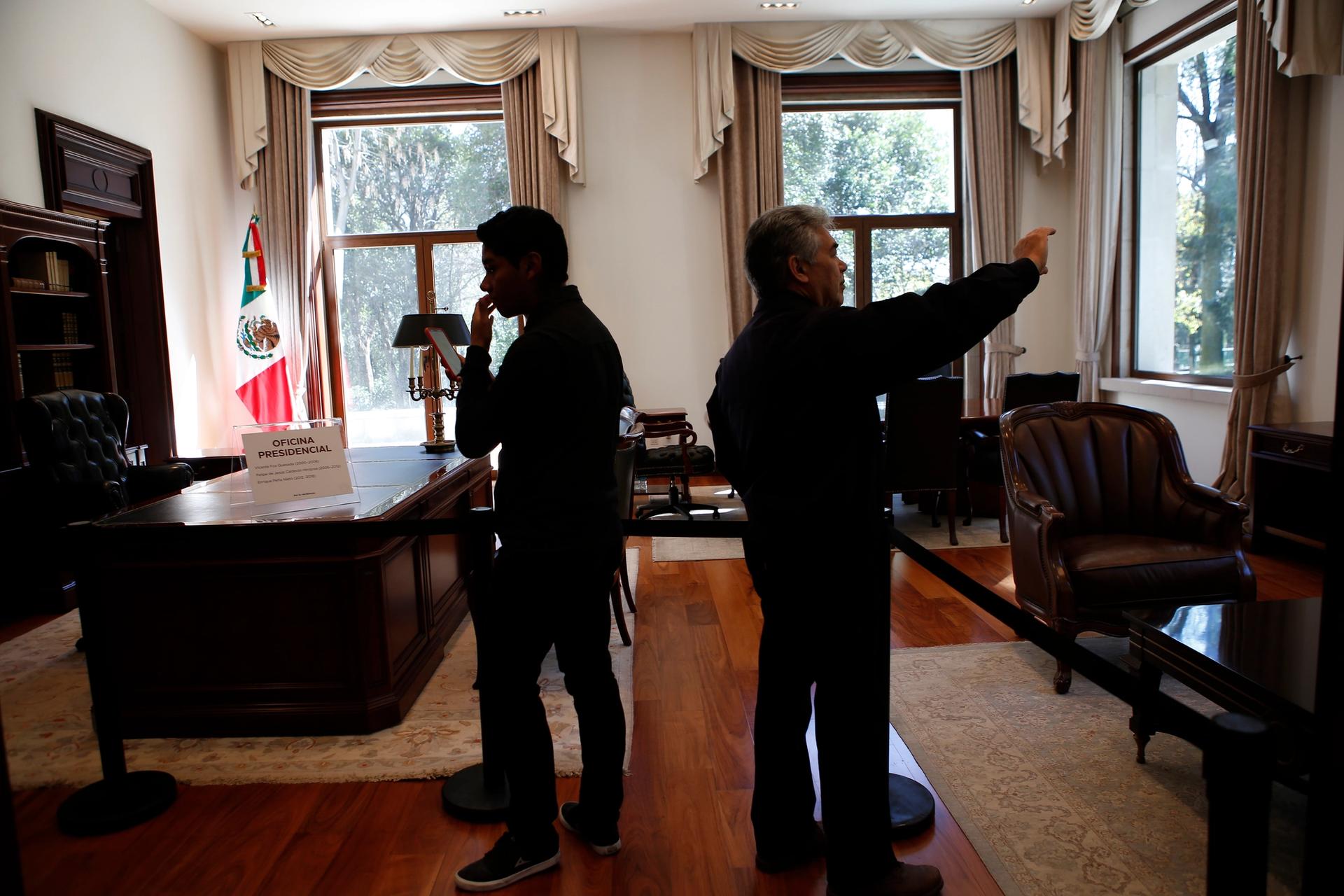 Visitors take photos inside the former presidential office at Los Pinos in Mexico City AP Photo/Ginnette Riquelme