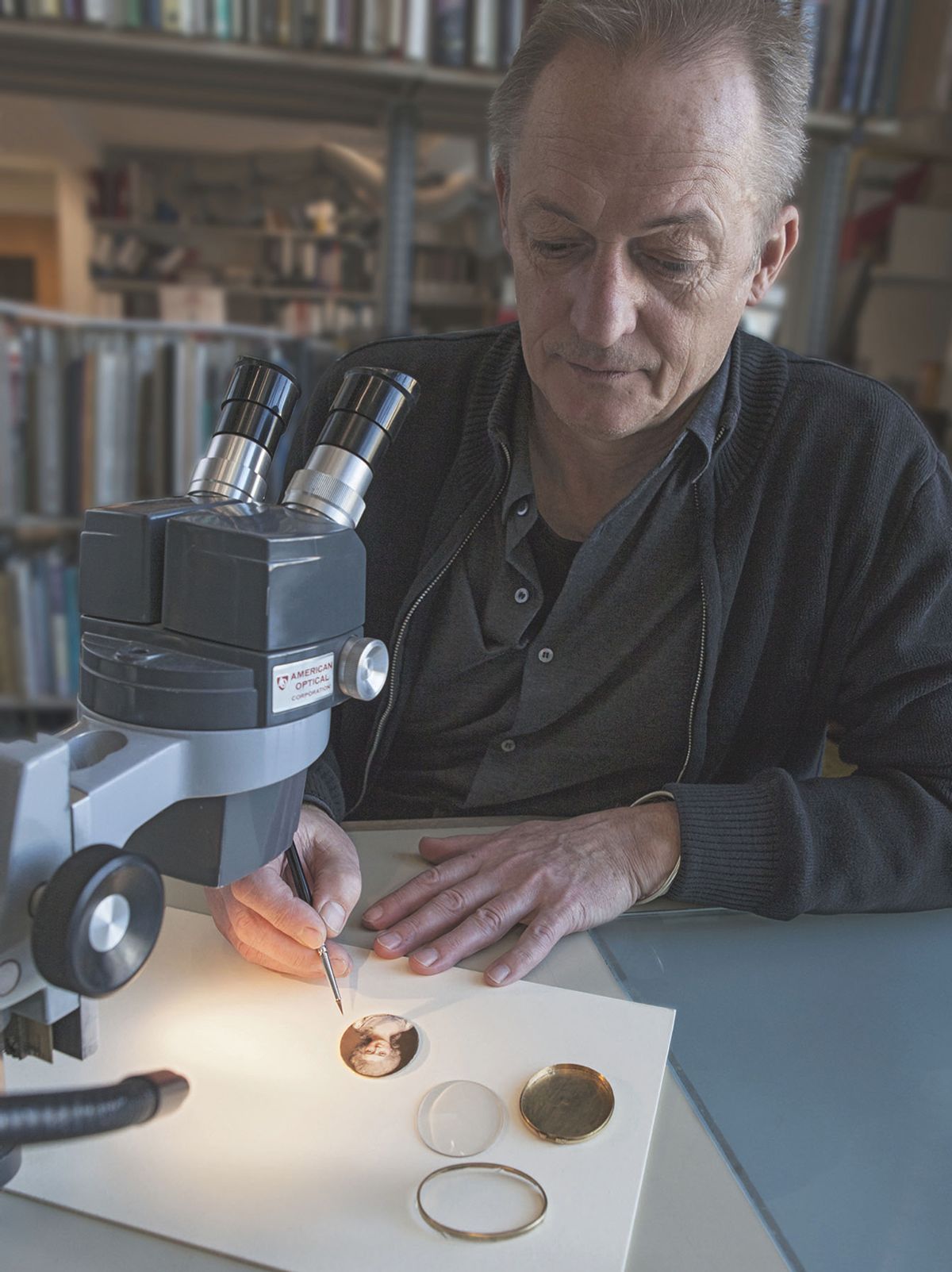 The Plowden Medal-winning portrait miniatures expert Alan Derbyshire analyses a work in the V&A’s conservation department © The Victoria and Albert Museum, London