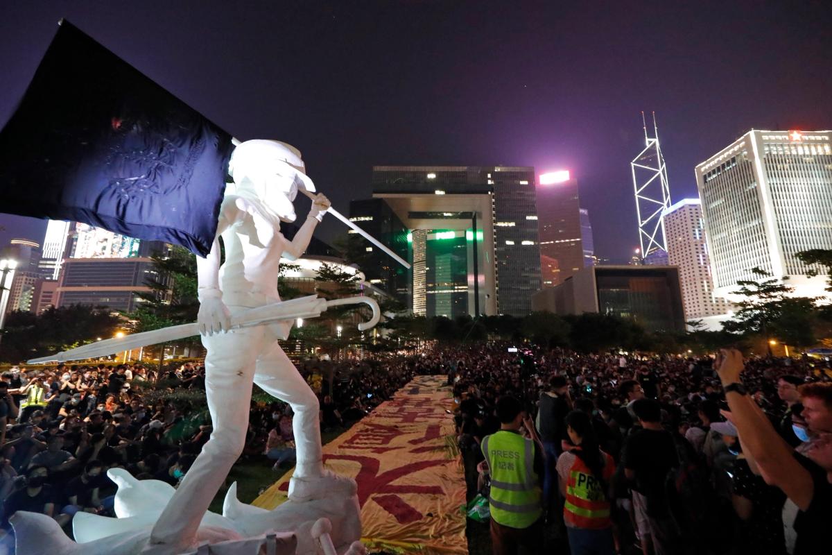 Protestors gather near the Lady Liberty statue, depicting a protestor, at Tamar Park in Hong Kong, Saturday, 28 September 2019 AP Photo/Vincent Thian