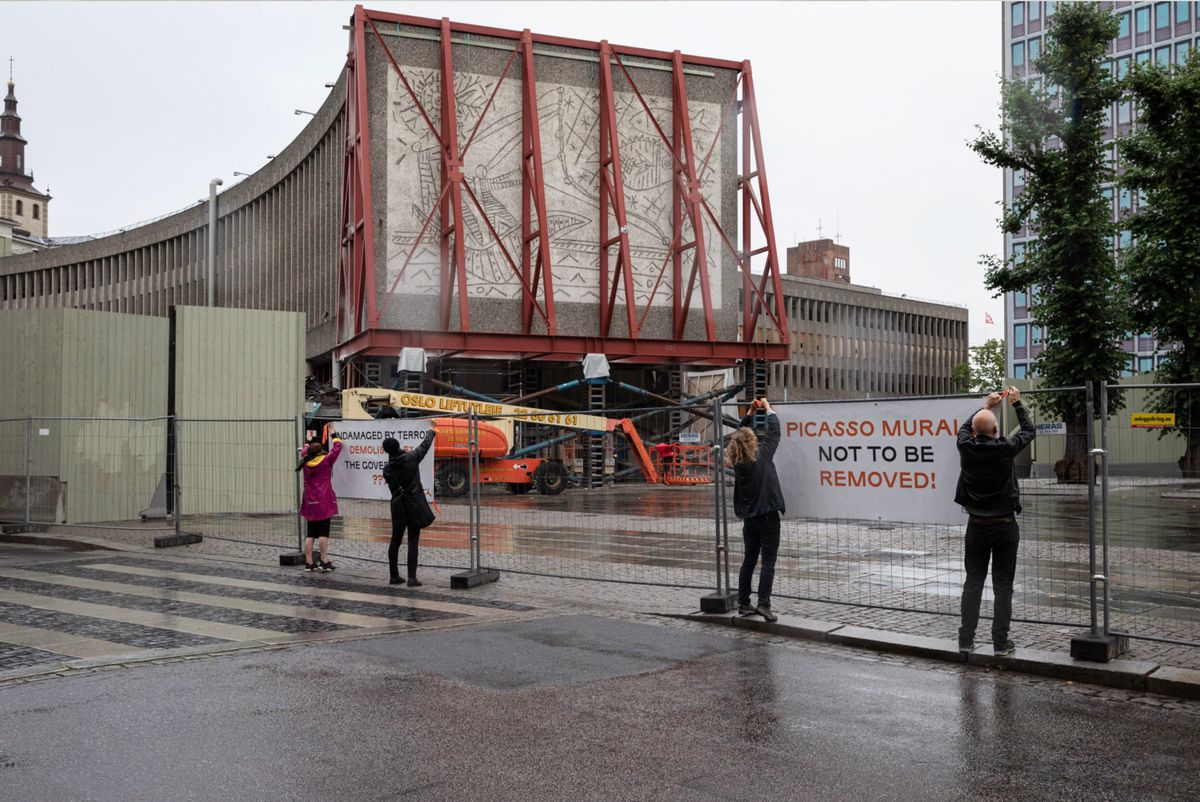 Protesters hanging up posters outside the demolition site for the Y Block building on 28 July Photo: © Adrian Bugge