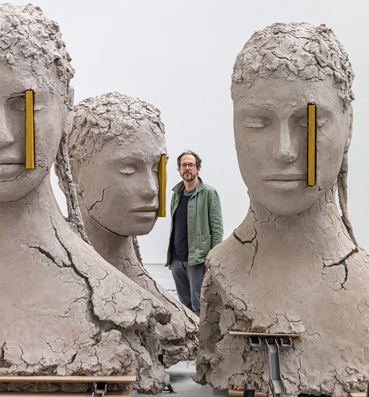 Mark Manders next to Composition with Four Yellow Verticals (2017-19). His work has been described as “one endless and ever-expanding self-portrait” Photo: Tim Van de Velde; courtesy the artist and Xavier Hufkens, Brussels