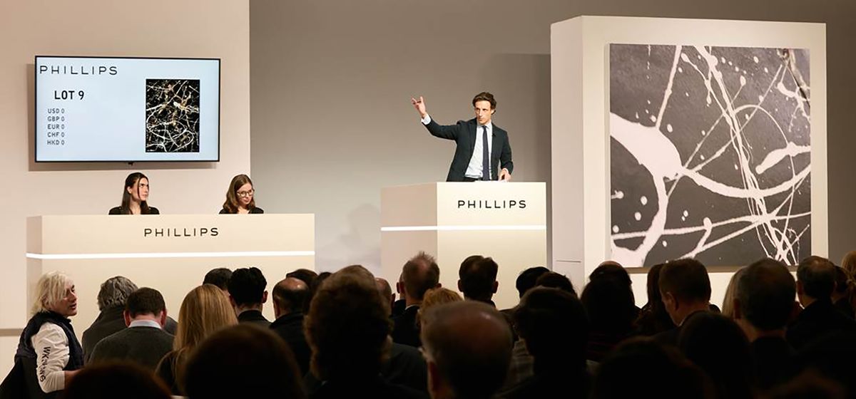 Phillips auctioneer Henry Highley fields bids for the night's top lot, Jackson Pollock's Untitled (around 1948) Courtesy Phillips