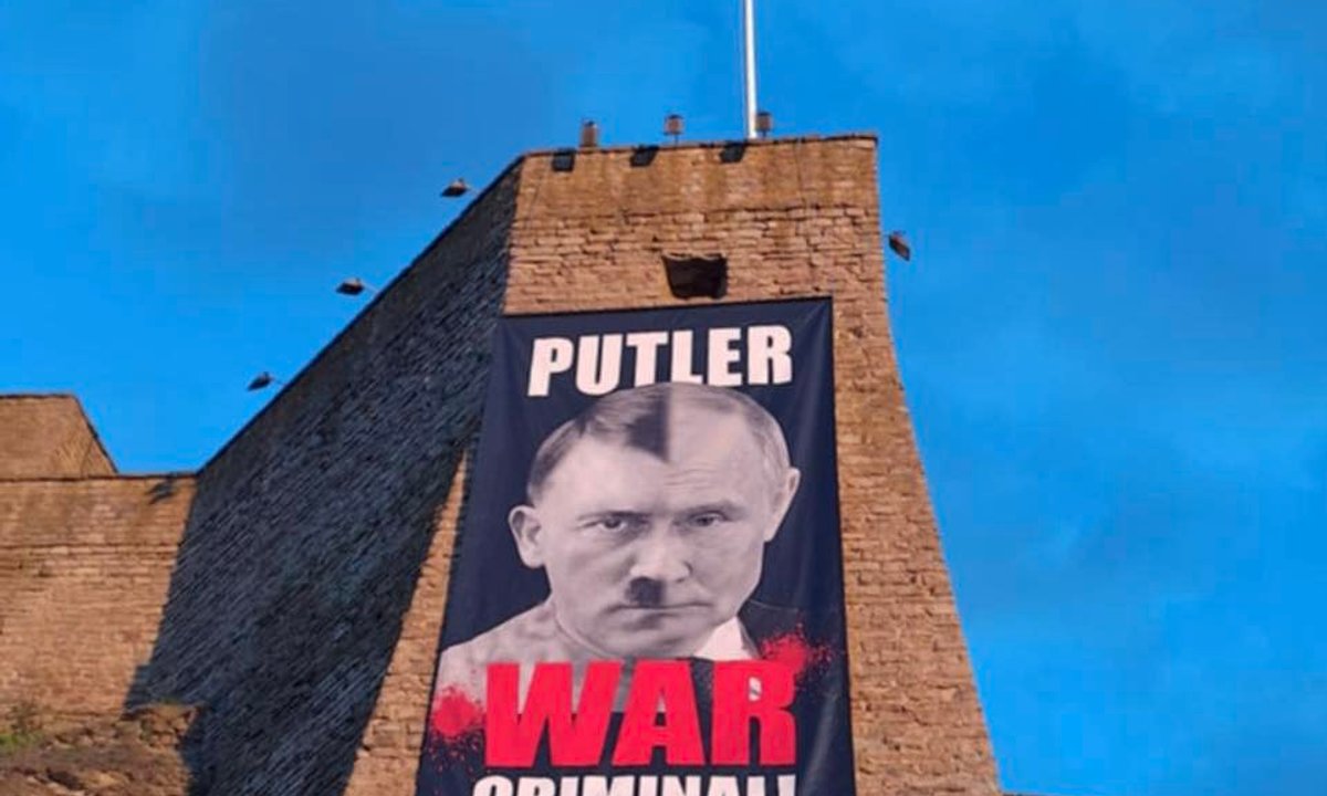 Russia charges Estonian museum director with 'rehabilitating Nazism' over Putin-Hitler banner