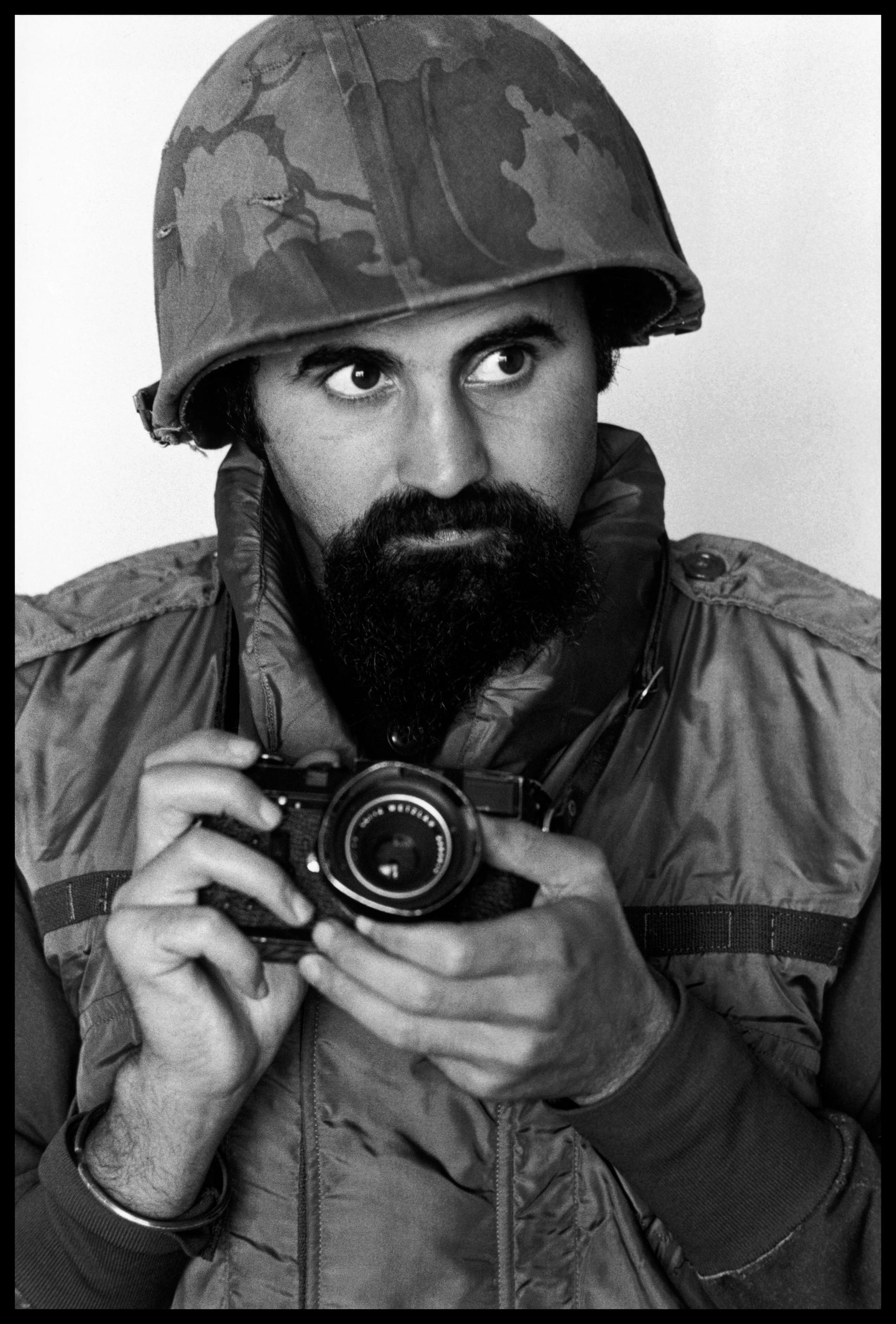 Abbas wears helmet and flack-jacket while covering the war in South Vietnam, 1973 A. Abbas / Magnum Photos