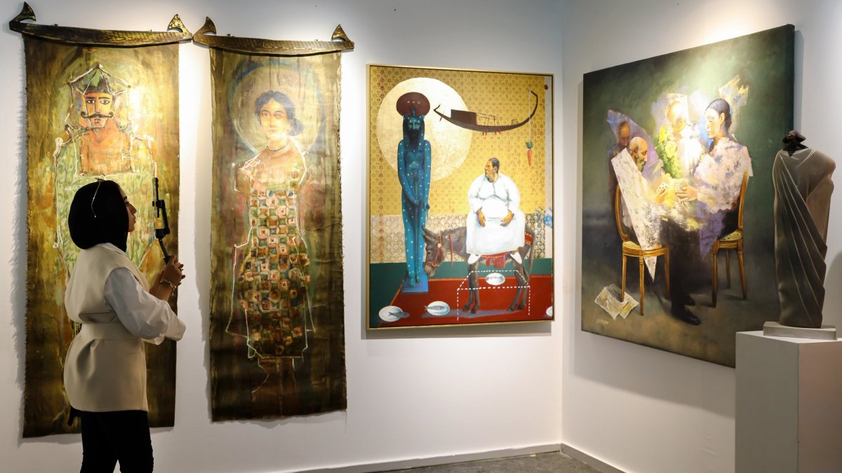 A visitor to a booth at Art Cairo © Art Cairo