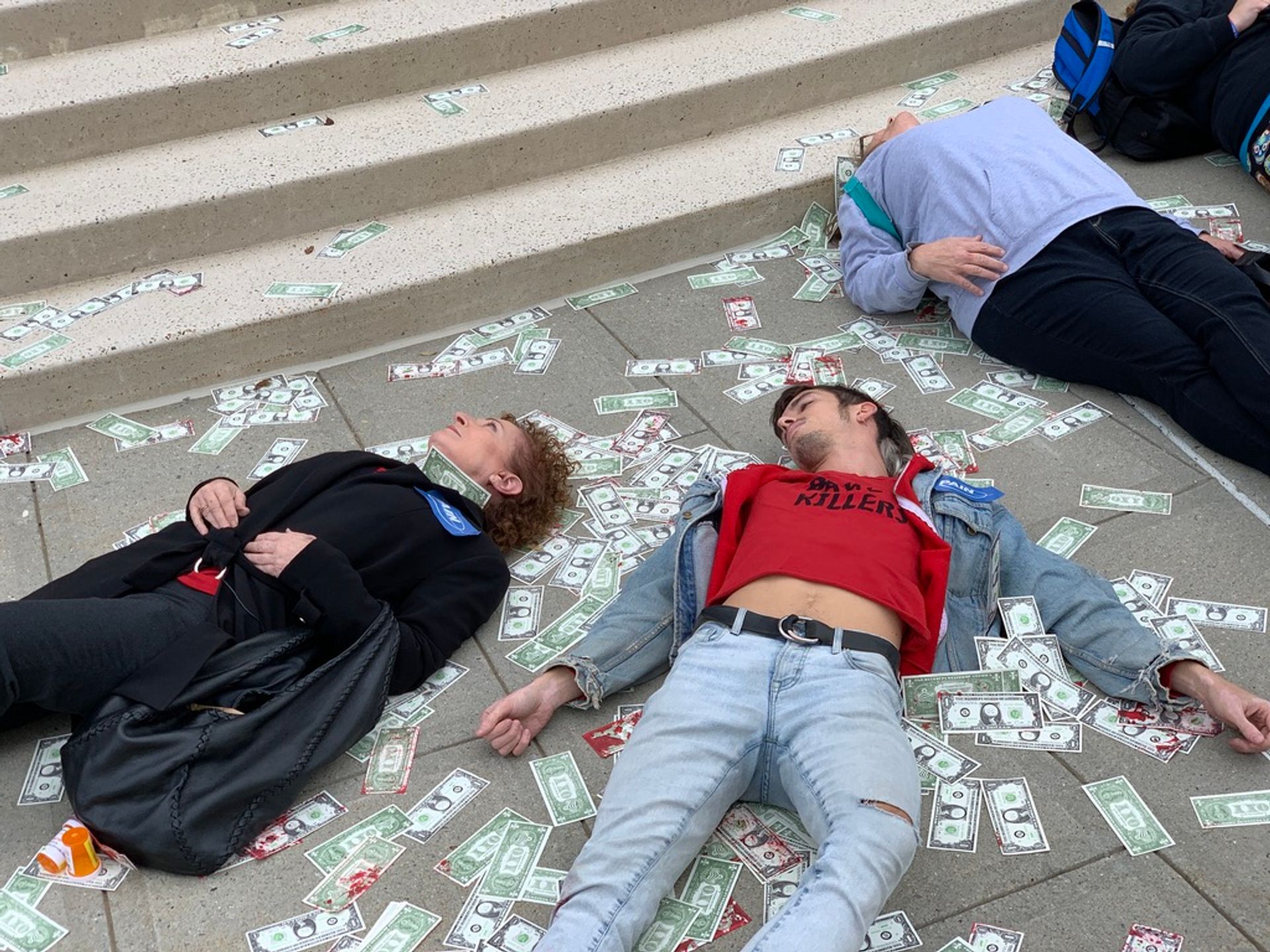 Goldin and activists from the groups PAIN and Truth Pharm tossed blood-soaked dollar bills into the air to represent the billions in profits that Purdue and the Sacklers have made from the sale of painkillers over the last two decades Photo: Zachary Small