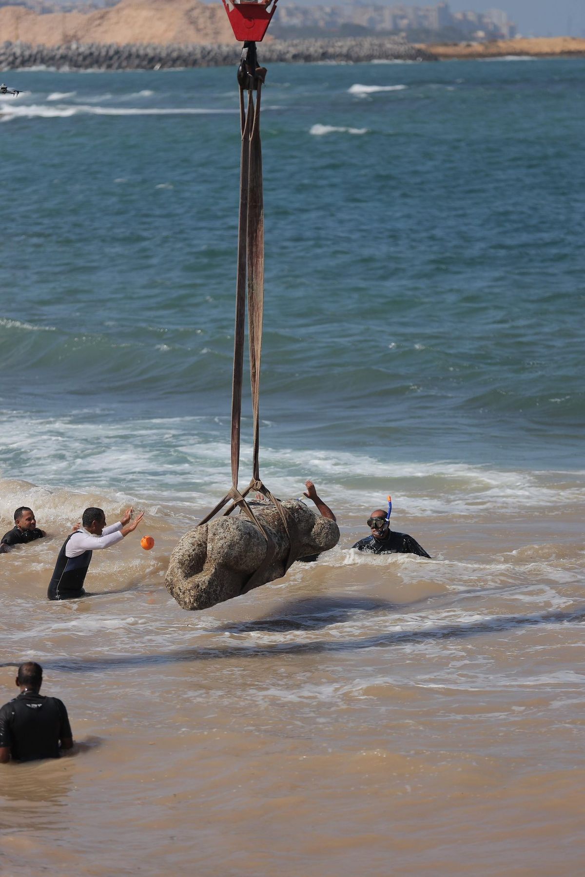 Divers and archaeologists help retrieve a submerged antiquity from the site of Canopus off the coast of Alexandria in Egypt Courtesy the Ministry of Tourism and Antiquities of Egypt