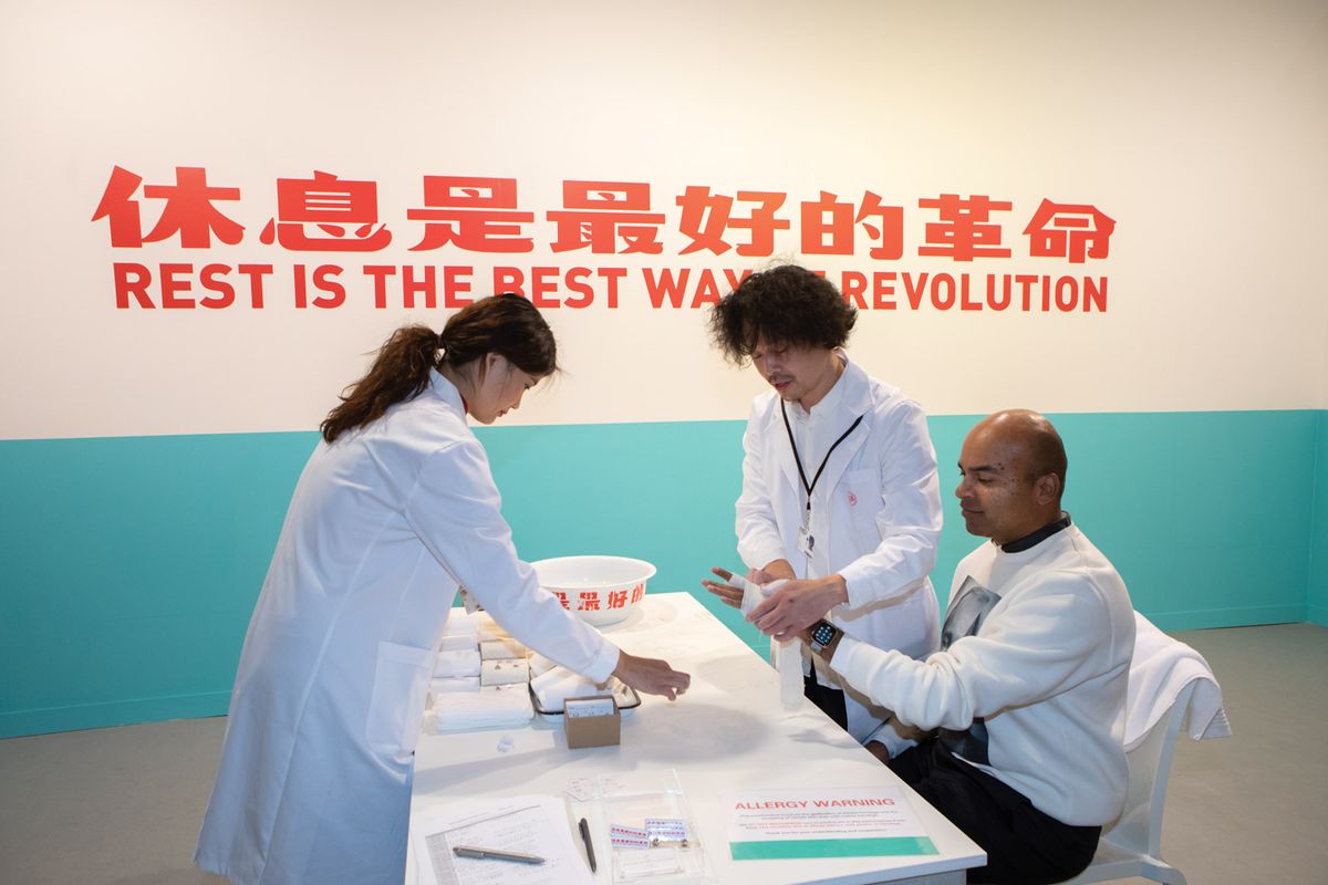 The doctor will see you now: Tang Dixin offers a cure for world-weary fairgoers © David Owens