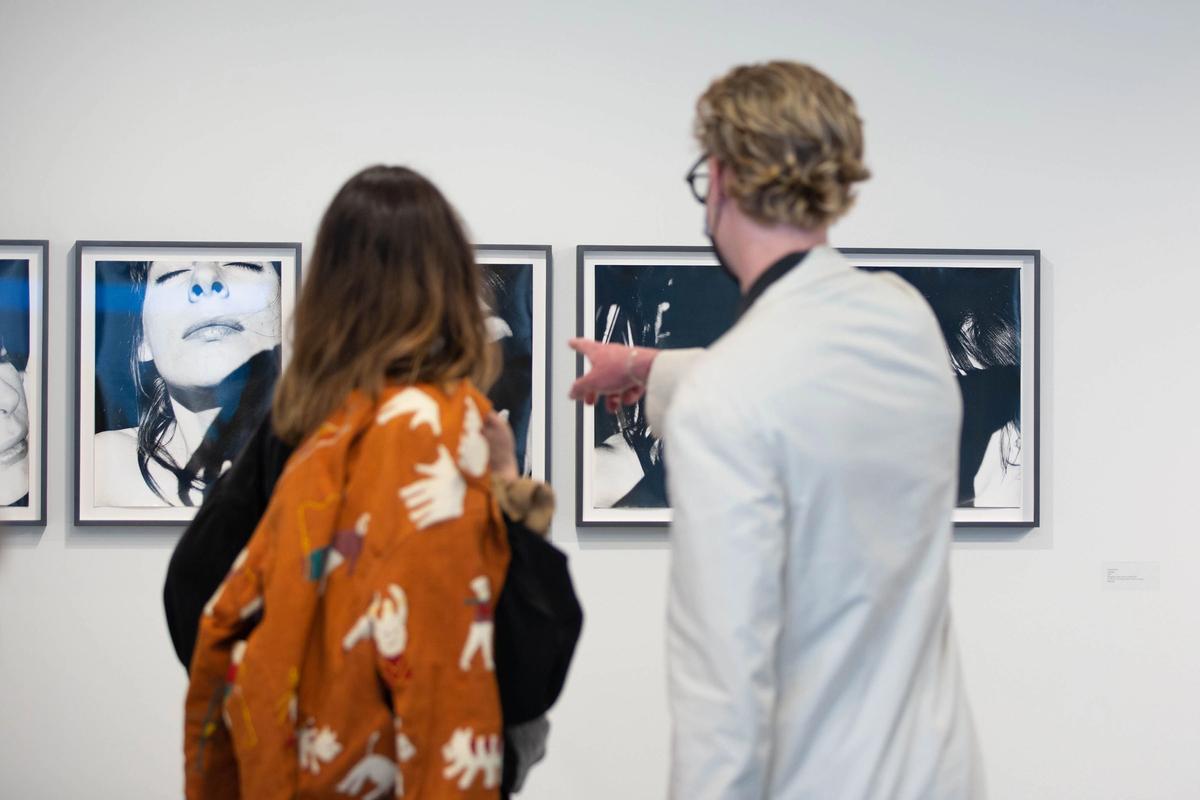 Visitors in the Higher Pictures Generation stand at Independent looking at photos by Janice Guy Courtesy of Higher Pictures Generation and Independent New York