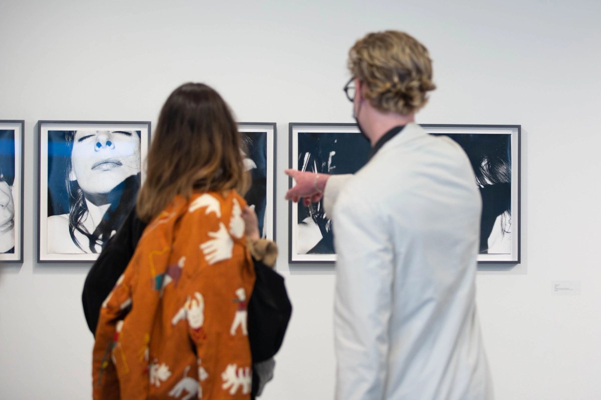 Visitors in the Higher Pictures Generation stand at Independent looking at photos by Janice Guy Courtesy of Higher Pictures Generation and Independent New York