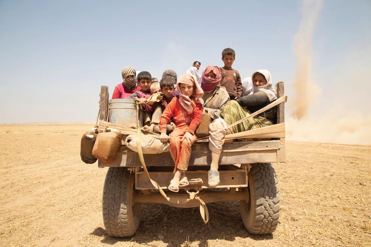 Yazidi fleeing on a truck, Sinjar, Iraq, 2014. Photo: Zmnanko Ismael. Courtesy of Nobody's Listening © Yazidi Cultural Archives