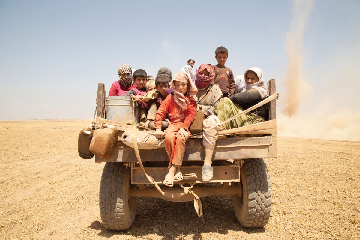 Yazidi fleeing on a truck, Sinjar, Iraq, 2014. Photo: Zmnanko Ismael. Courtesy of Nobody's Listening © Yazidi Cultural Archives