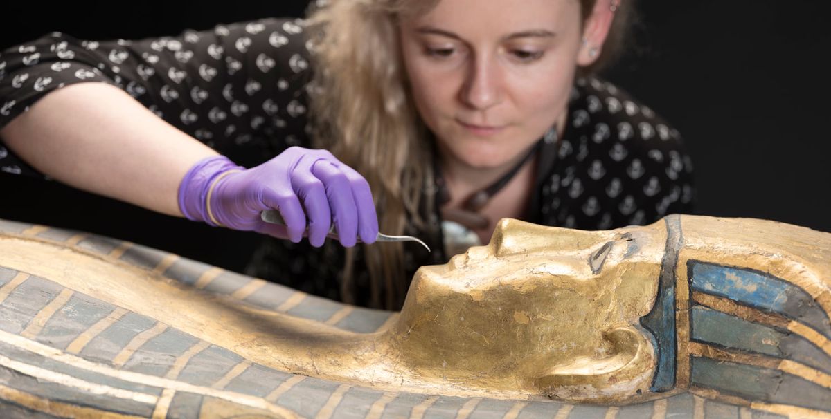 Assistant conservator Bethan Bryan works on a coffin from the Qurna burial group © National Museums Scotland