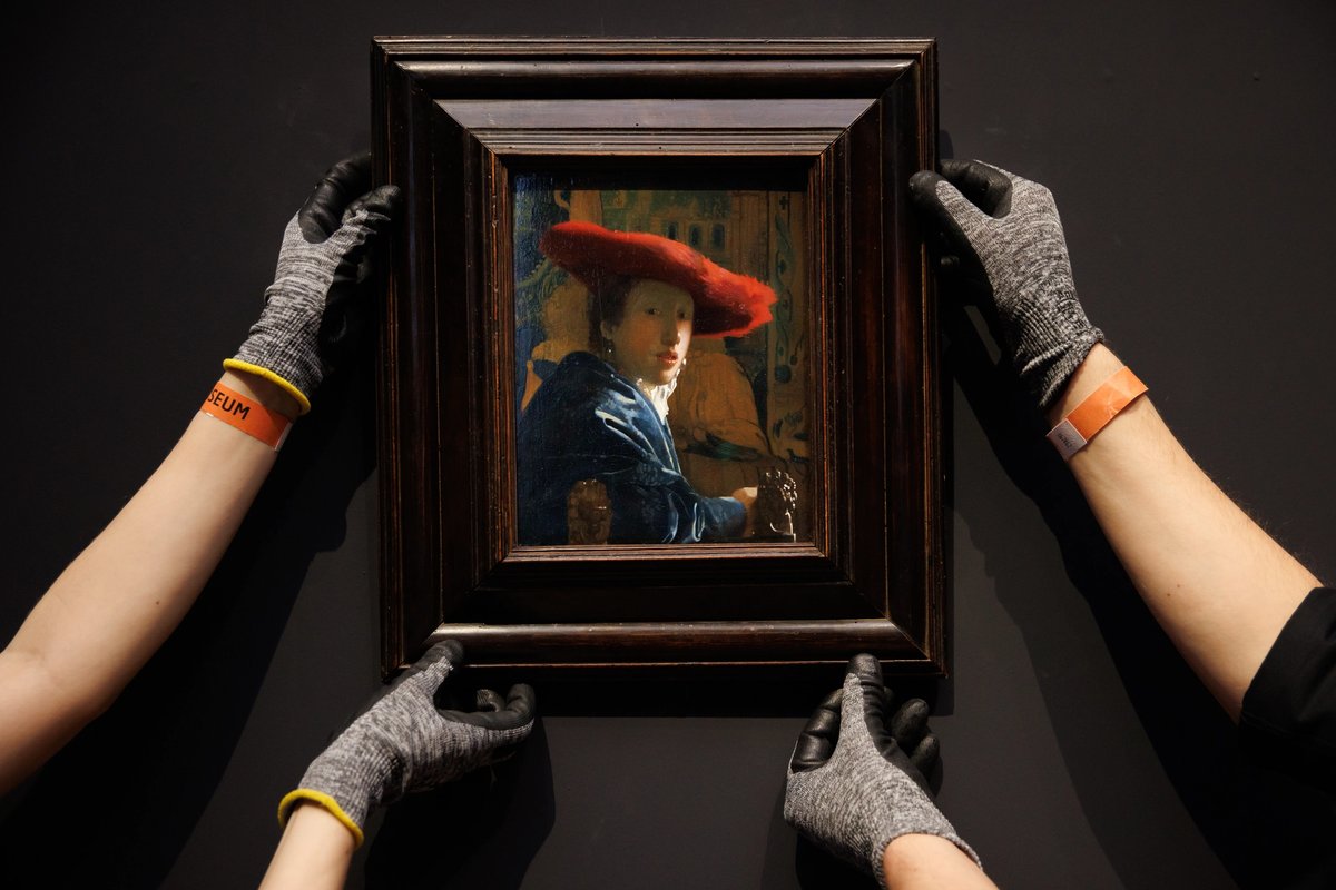 Art handlers install Johannes Vermeer's Girl with a Red Hat (around 1669) for the Rijksmuseum's new show
Photo: Rijksmuseum/Kelly Schenk