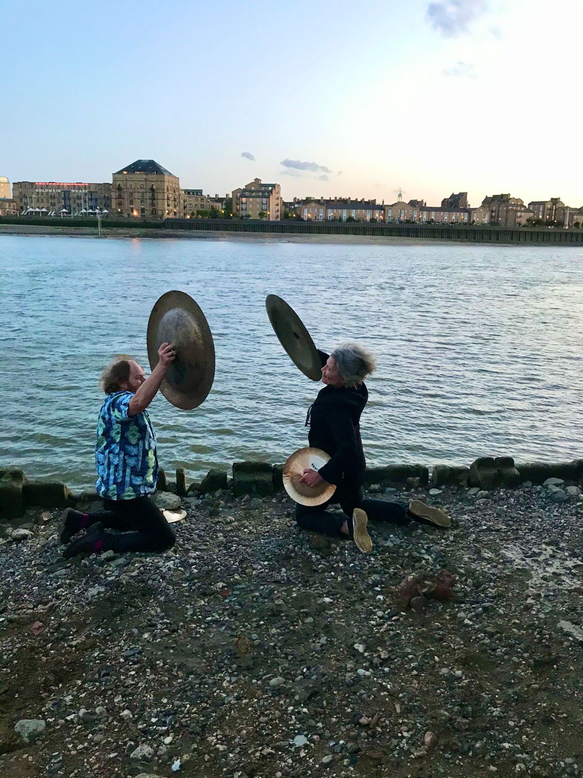The artists Richard Wilson and Anne Bean performing by the River Thames