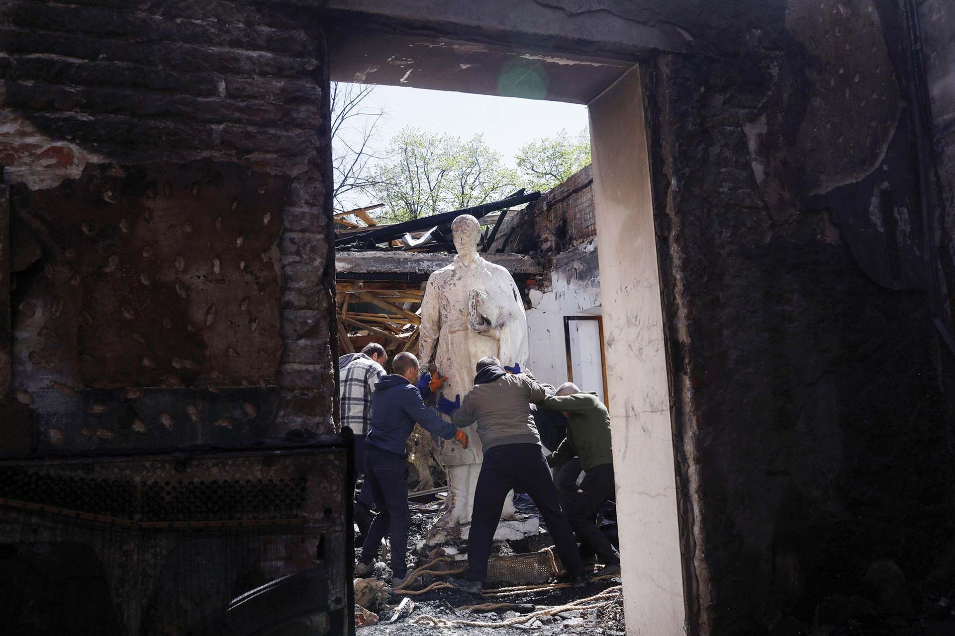 Workers remove a statue at the Hryhoriy Skovoroda Literary Memorial Museum, near Kharkiv, following Russian bombing. Ukraine’s heritage has suffered catastrophic damage during the Russian invasion Ricardo Moraes/REUTERS



