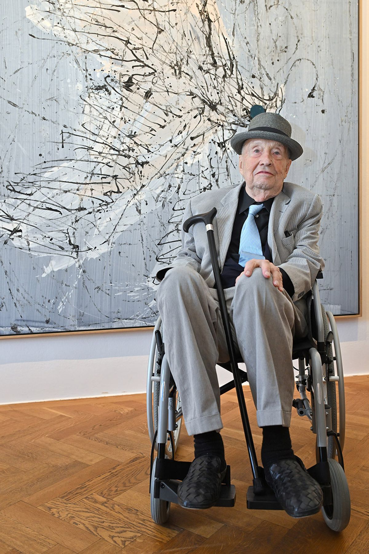 As part of a new process, Baselitz is pulled on a rope across his canvas by an assistant
Kerstin Joensson/Getty Images