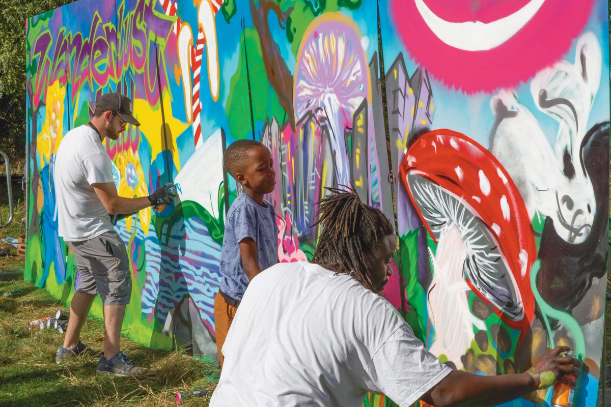 Creating a mural during the Thamesmead Festival, in London in August; providing low-cost studios for artists has been a key part of rejuvenating the 1960s Brutalist estate © Rosie Reed Gold