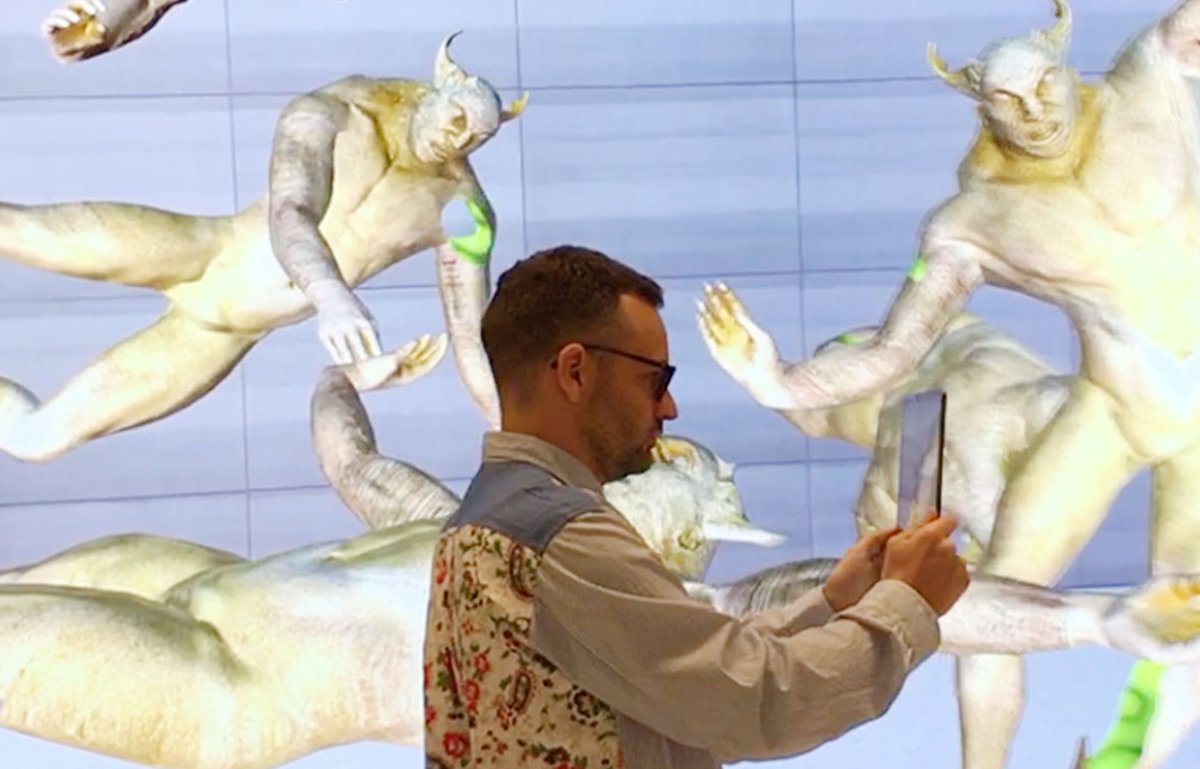 So meta: Edward Cutting, of Tin&Ed, demonstrates United Visions AR experience at the new Apple Store in Brompton Road, central London Louis Jebb