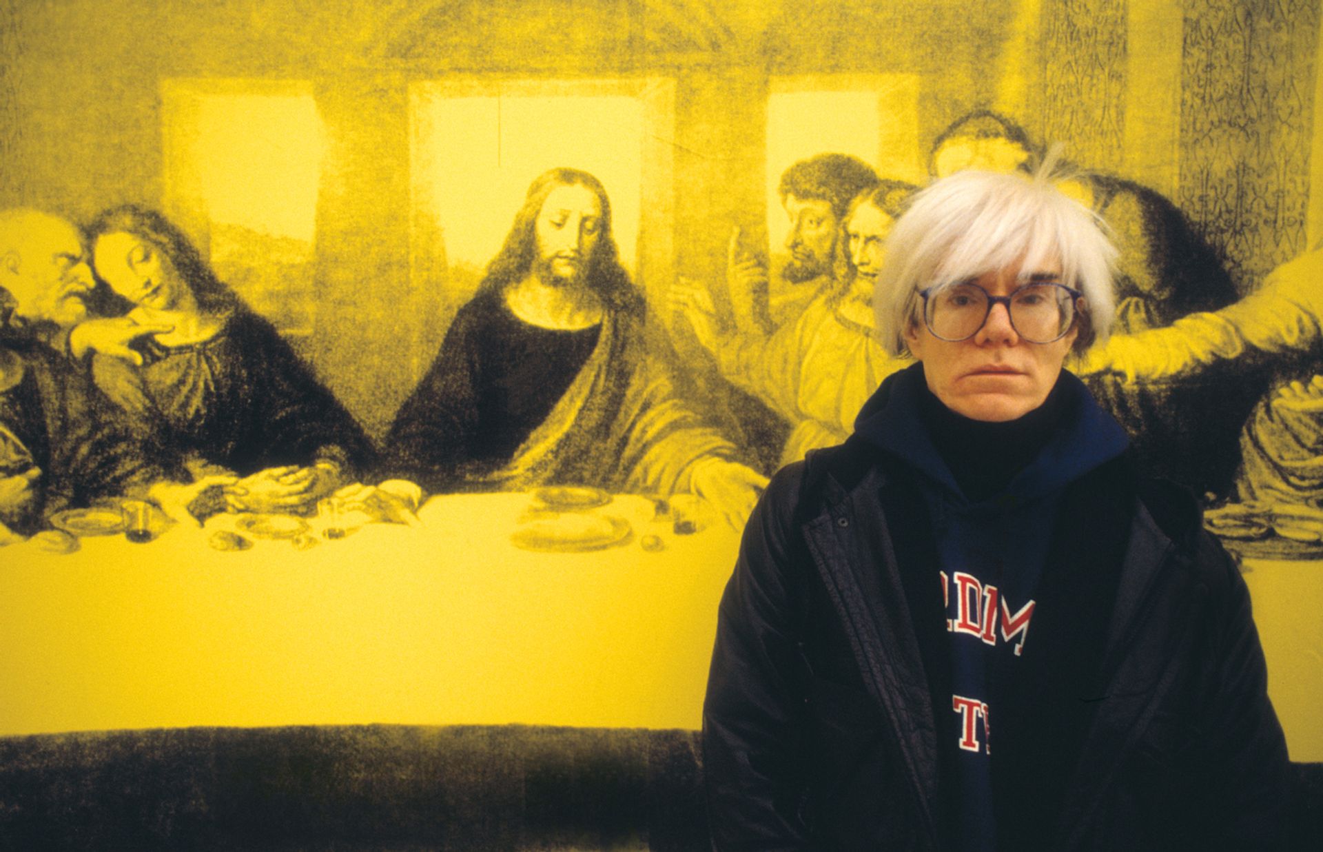 Andy Warhol in front of a version of The Last Supper, in Milan in 1987 Photo by Giorgio Lotti/Archivio Giorgio Lotti/Mondadori Portfolio via Getty Images