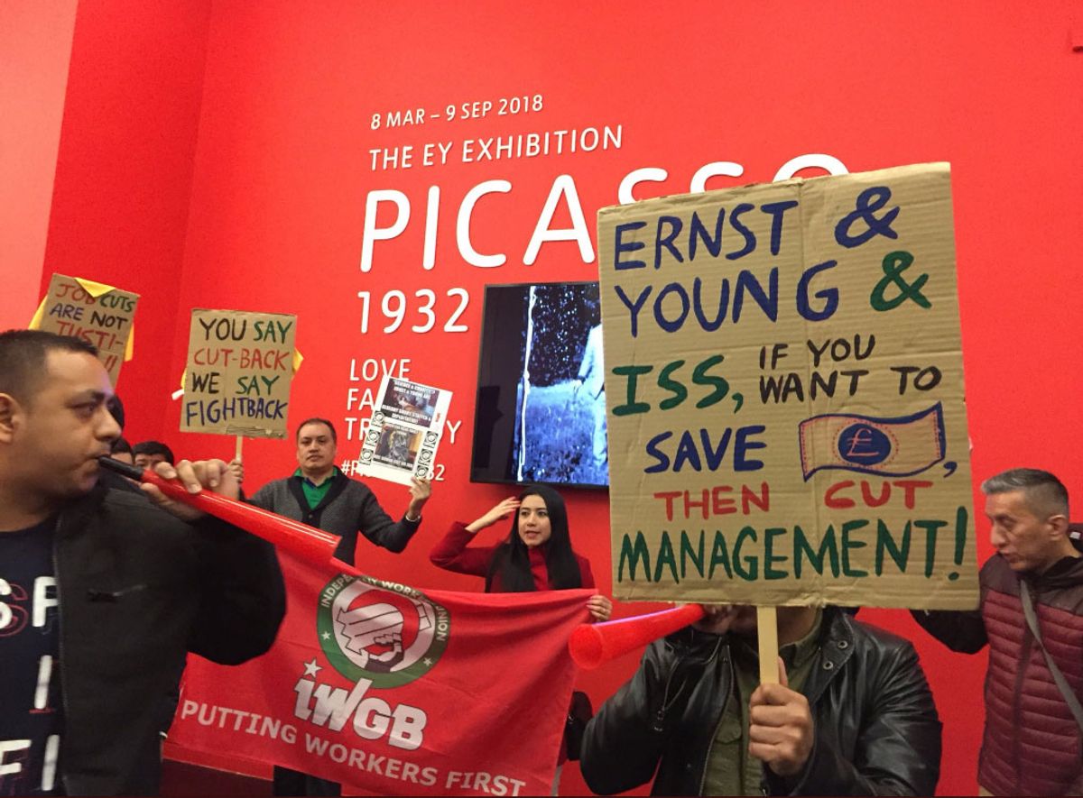 IWGB hold up signs in support of the cleaners Lydia Hughes